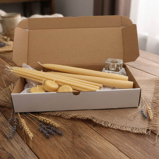 Set of beeswax candles and candle holders in a box